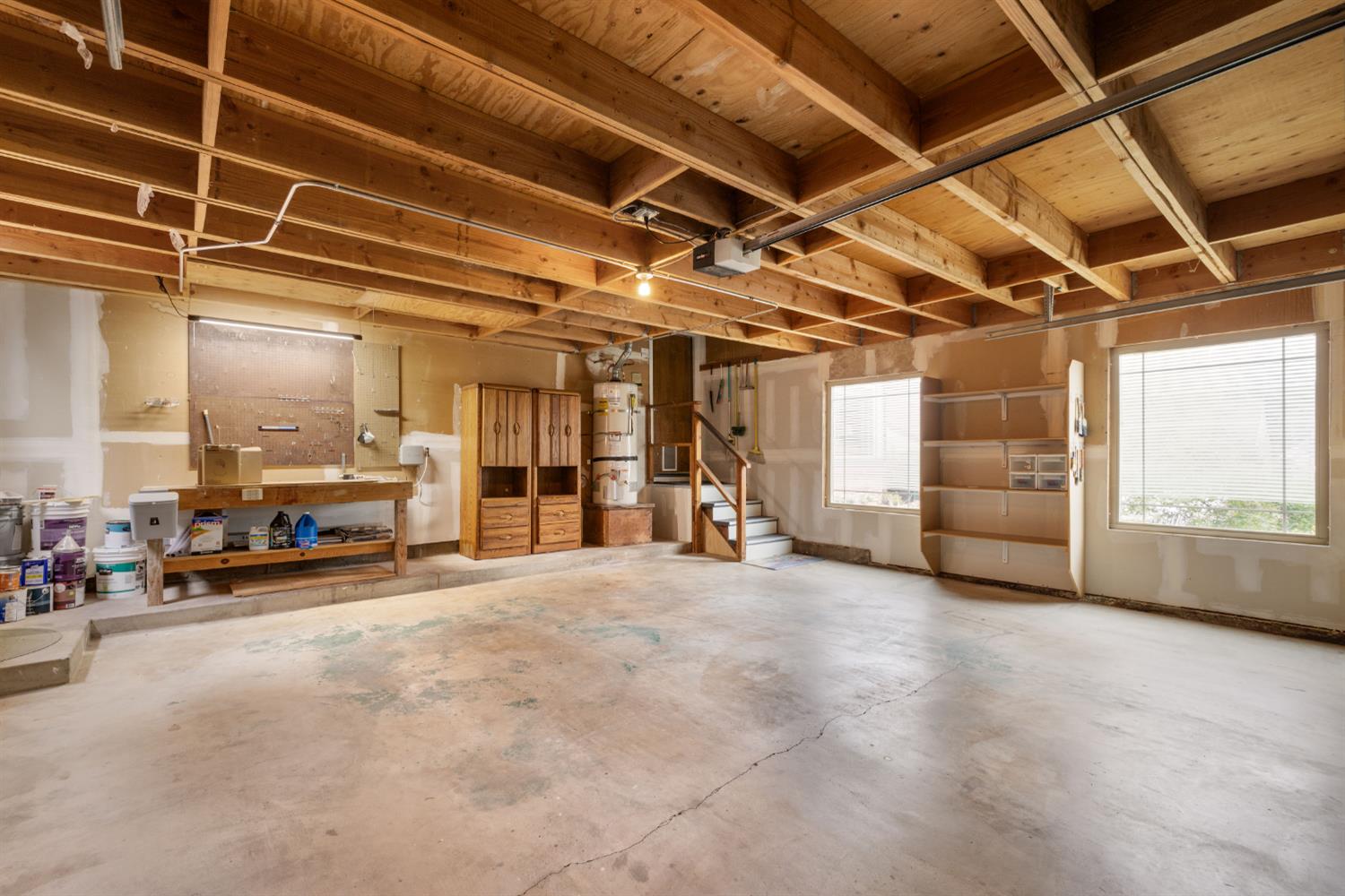 7118 Murdock Way Carmichael, CA 95608 - Photo 26 of 31 Two car garage has large attic space above for storage and a dumbwaiter device to bring items up and down to the attic. Workbench table and cabinetry in garage as well.