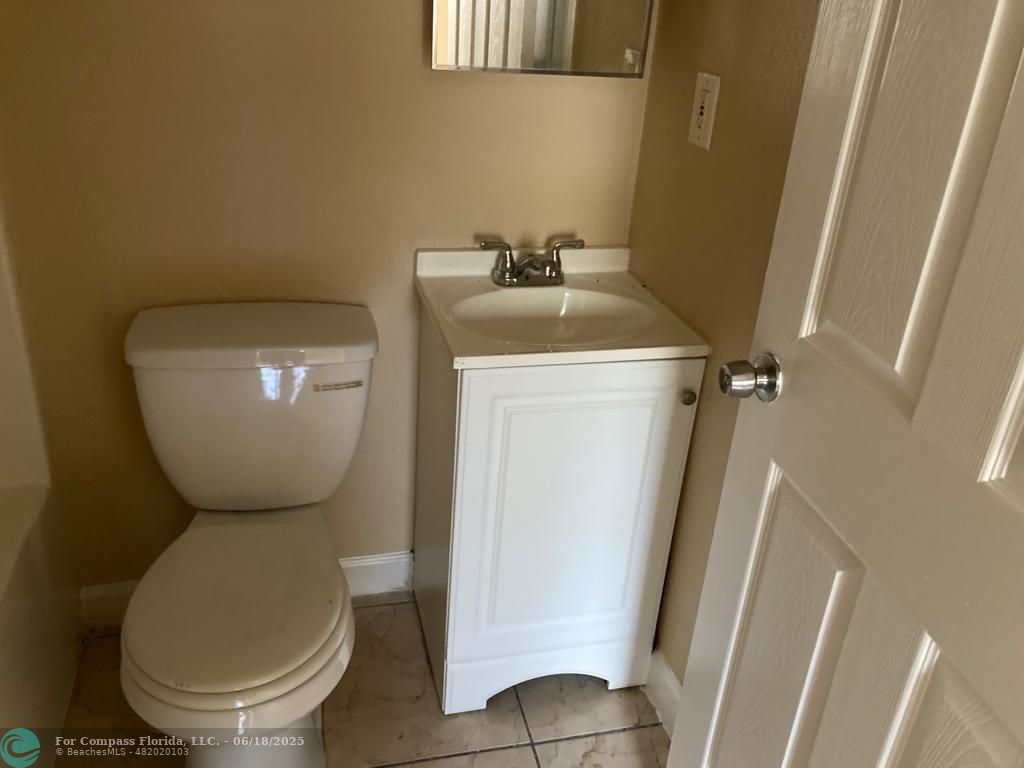 179 South Barfield Highway, Unit 1 Pahokee, FL 33476 - Photo 11 of 19 a bathroom with a toilet and a sink