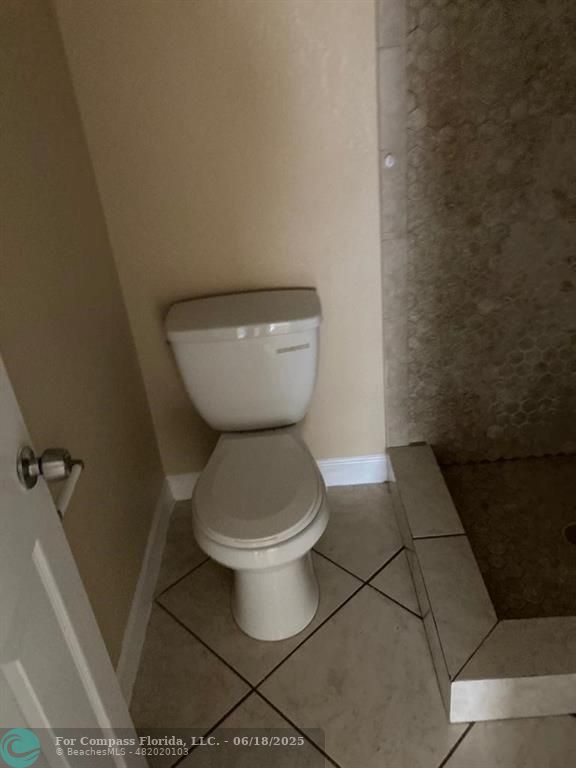 179 South Barfield Highway, Unit 1 Pahokee, FL 33476 - Photo 14 of 19 a bathroom with a toilet