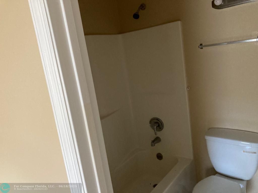 179 South Barfield Highway, Unit 1 Pahokee, FL 33476 - Photo 16 of 19 a bathroom with a shower and toilet
