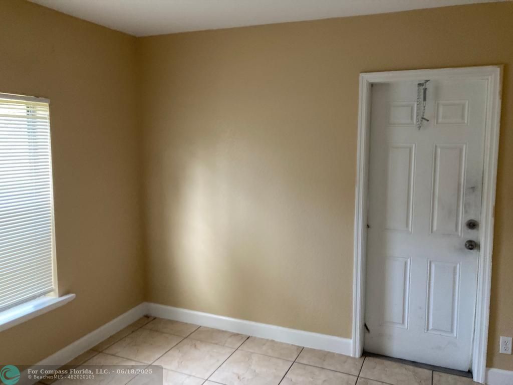 179 South Barfield Highway, Unit 1 Pahokee, FL 33476 - Photo 17 of 19 an empty room with windows