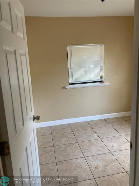 179 South Barfield Highway, Unit 1 Pahokee, FL 33476 - Photo 18 of 19 a view of a small space with wooden floor and staircase