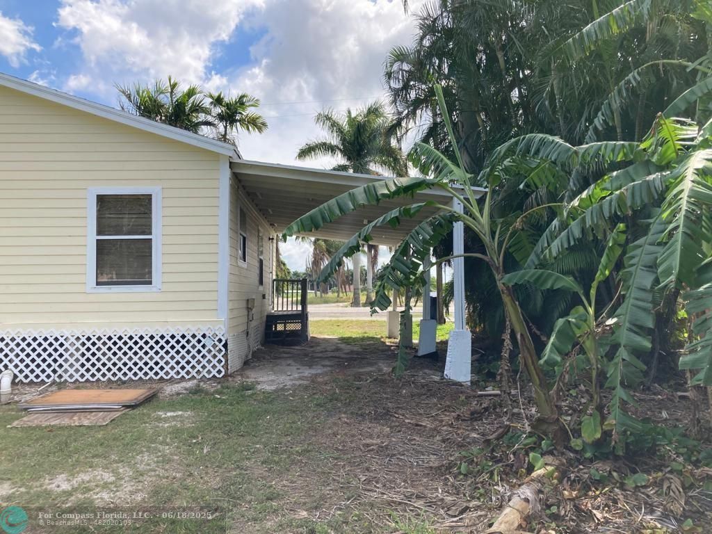 179 South Barfield Highway, Unit 1 Pahokee, FL 33476 - Photo 4 of 19 a view of a house with a backyard