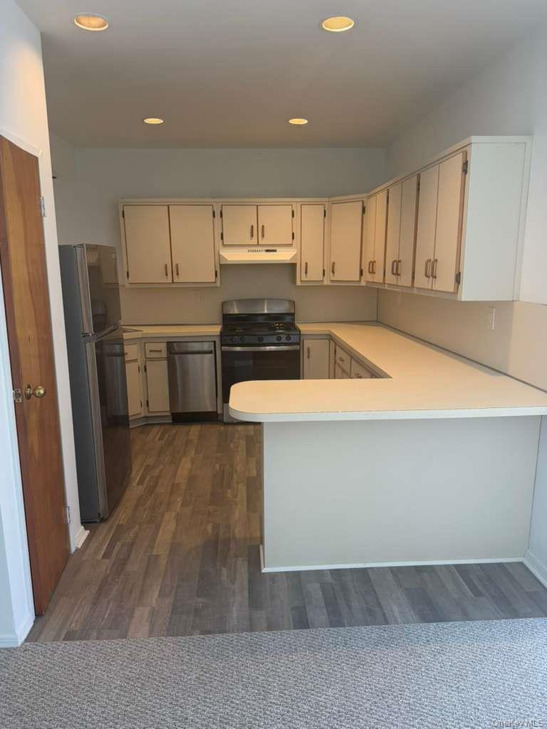 663 92nd Street Brooklyn, NY 11228 - Photo 3 of 6 a kitchen with a refrigerator and a stove