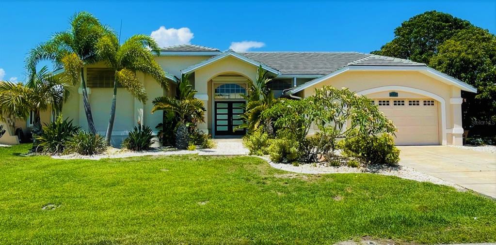 822 Vía Formia Punta Gorda, FL 33950 - Photo 1 of 1 a front view of a house with a yard