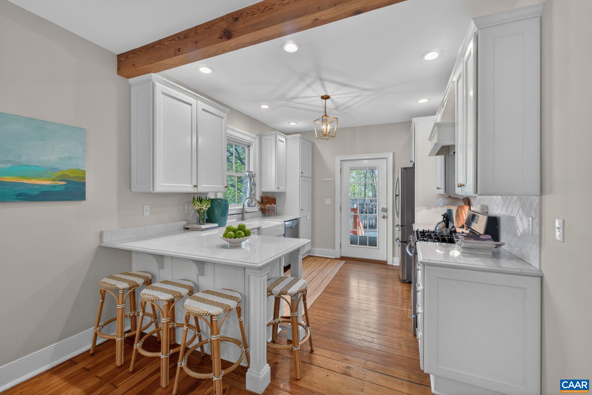 623 Hinton Avenue Charlottesville, VA 22902 - Photo 12 of 35 a kitchen with stainless steel appliances a table chairs refrigerator and sink