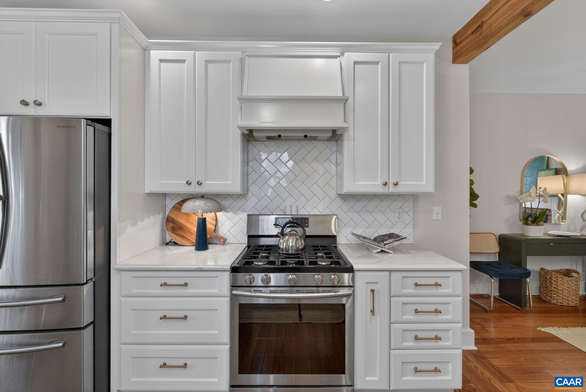 623 Hinton Avenue Charlottesville, VA 22902 - Photo 15 of 35 a kitchen with white cabinets and a stainless steel appliances