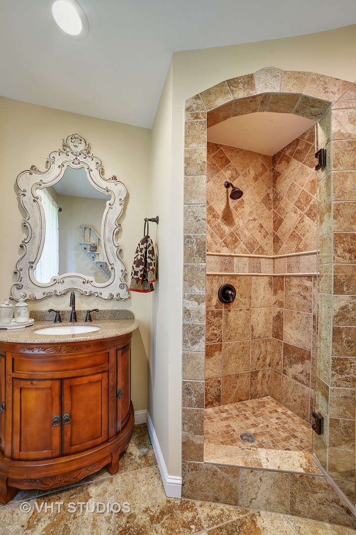 972 High Point Lane Streamwood, IL 60107 - Photo 14 of 26 a bathroom with a granite countertop sink a mirror and shower