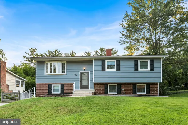 a view of a brick house with a yard