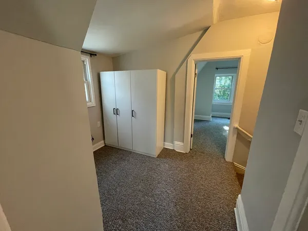 a view of hallway with wooden floor