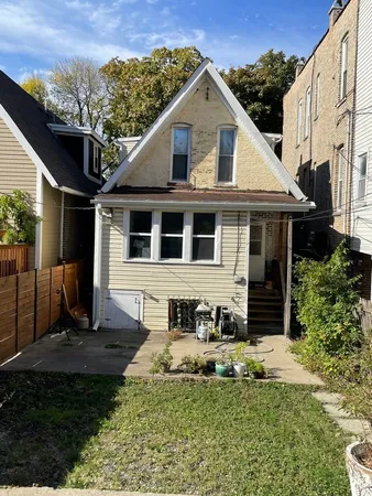 a view of house with outdoor space area and car parked