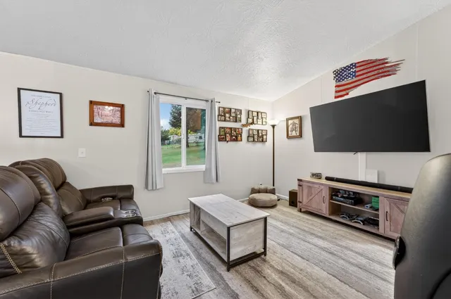 a living room with furniture and a flat screen tv