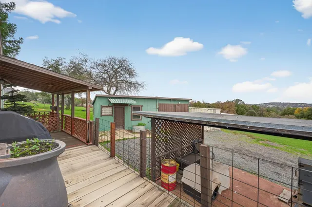 a view of a terrace with furniture and a garden