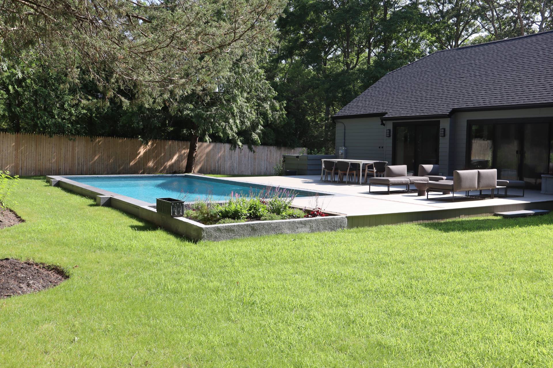 10 Hampton Street Westhampton Beach, NY 11978 - Photo 15 of 20 a wooden house with pool in front of it