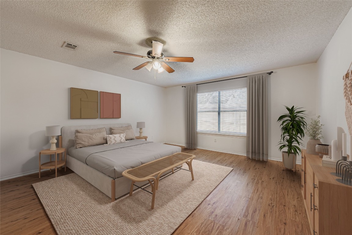 9839 Briar Ridge Drive Austin, TX 78748 - Photo 14 of 28 Bedroom featuring light wood finished floors, a ceiling fan, and a textured ceiling