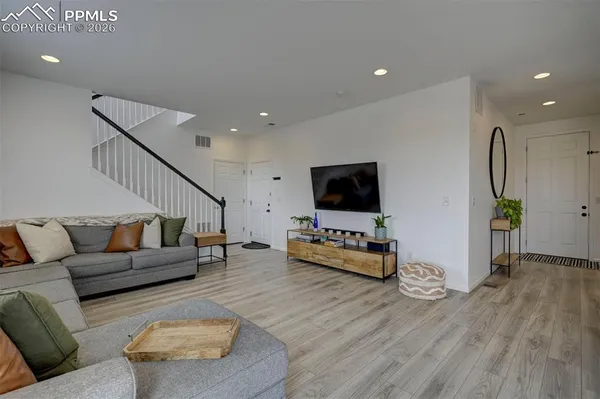 a living room with furniture and a flat screen tv