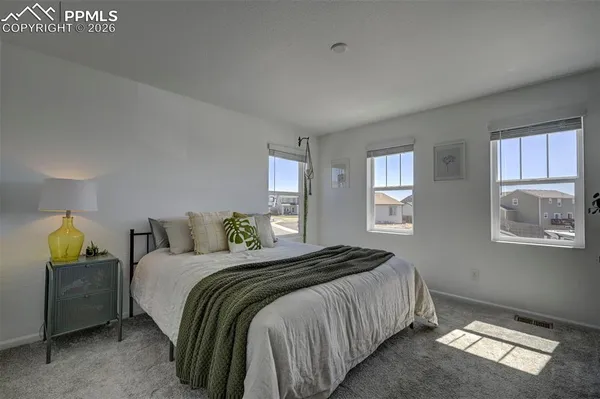 a bedroom with a bed and window