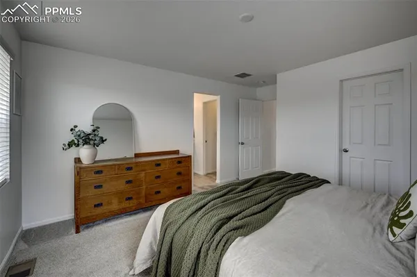 a bedroom with a bed and a dresser