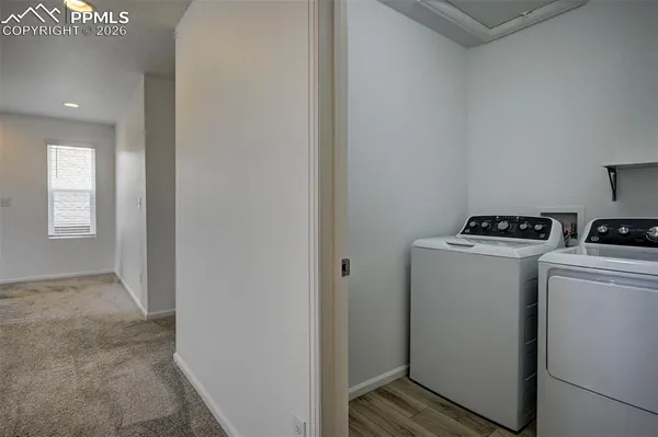a view of storage and utility room with washer and dryer