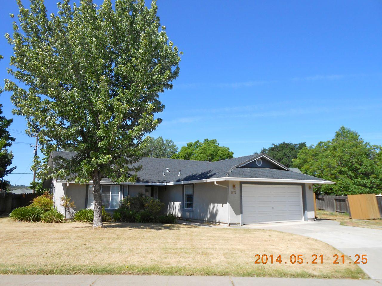 7072 Pit Road Redding, CA 96001 - Photo 3 of 20 a front view of a house with a yard
