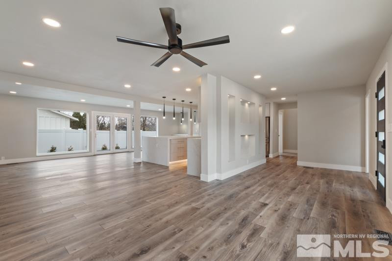 995 Skyline Boulevard Reno, NV 89509 - Photo 5 of 34 a view of a livingroom with a ceiling fan window a ceiling fan and wooden floor