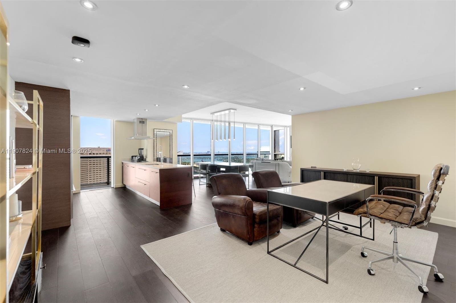 495 Brickell Avenue, Unit 4502 Miami, FL 33131 - Photo 5 of 15 a open kitchen with stainless steel appliances kitchen island granite countertop a table and chairs in it