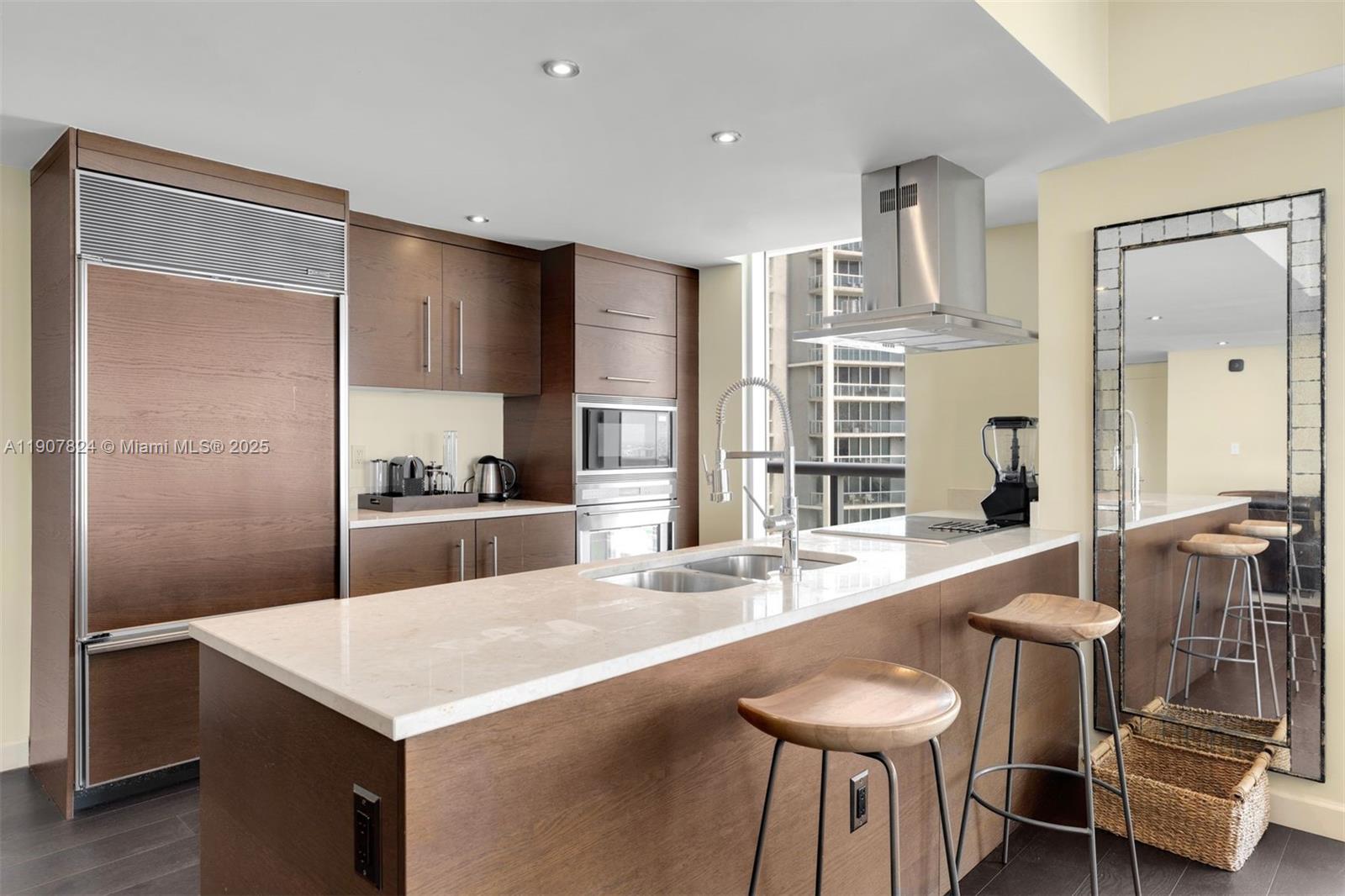 495 Brickell Avenue, Unit 4502 Miami, FL 33131 - Photo 7 of 15 a large kitchen with kitchen island a table and chairs