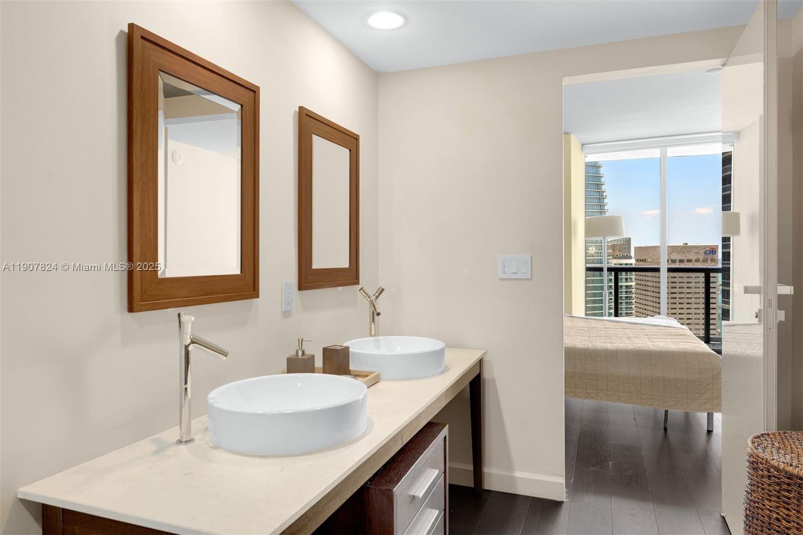 495 Brickell Avenue, Unit 4502 Miami, FL 33131 - Photo 8 of 15 a bathroom with double vanity sinks and a mirror