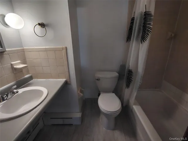 a bathroom with a toilet sink a mirror and vanity