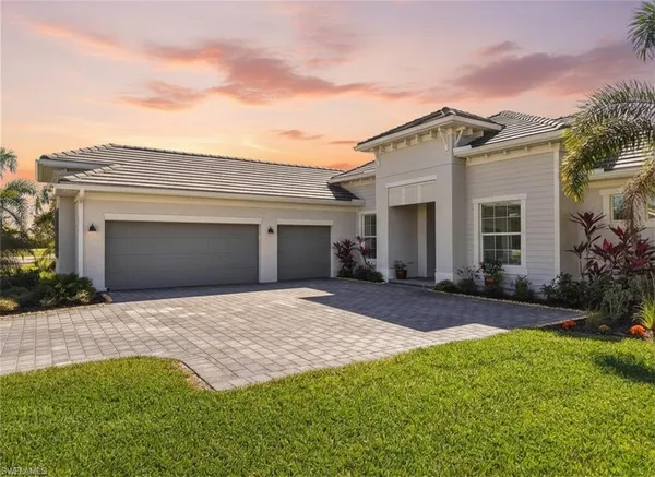 a front view of a house with a yard and garage