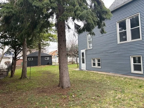 a view of a house with a tree in the yard