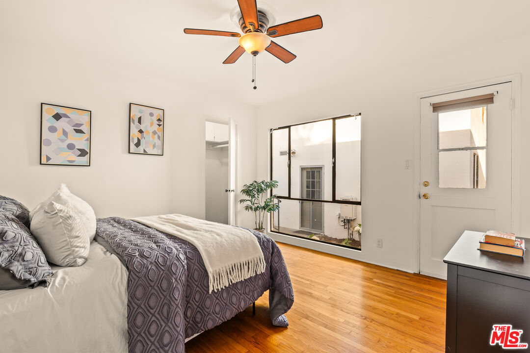 1100 Victoria Avenue Venice, CA 90291 - Photo 20 of 30 a bedroom with a bed and wooden floor
