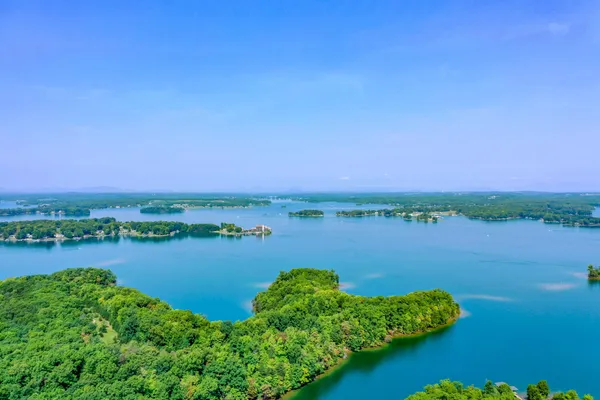 a view of a lake with houses in the back