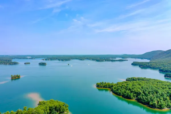 an aerial view of a house with a yard and lake view