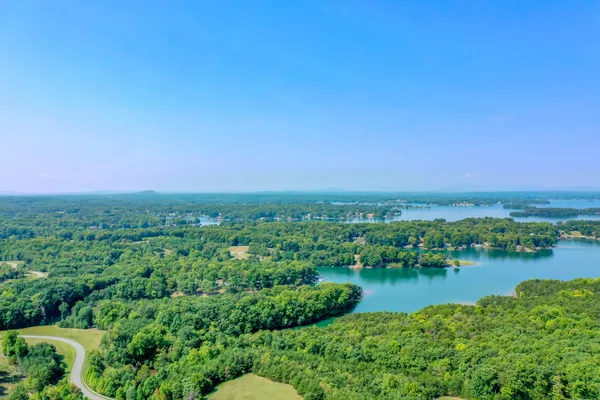 an aerial view of a house with a yard and lake view