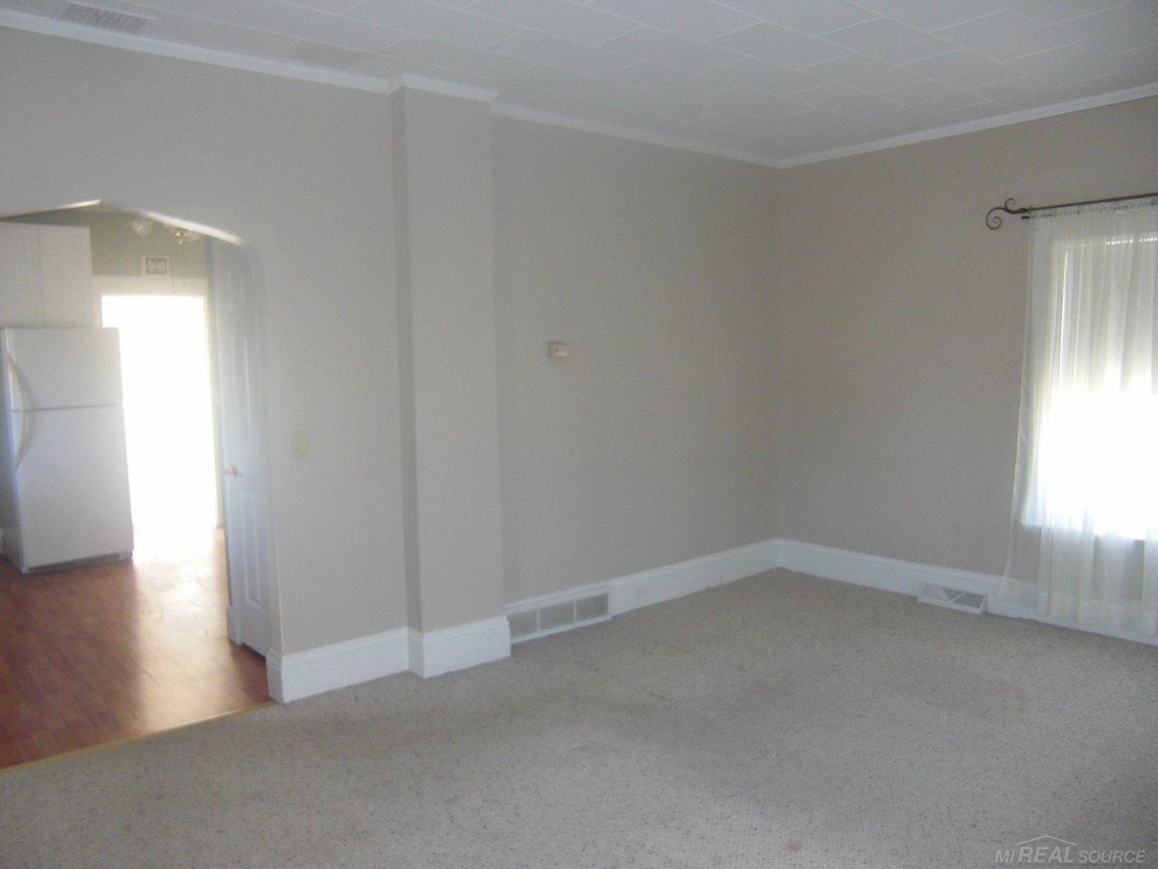 59 West Custer Road Sandusky, MI 48471 - Photo 8 of 25 Another view of the living room. You can see where it comes off from the kitchen