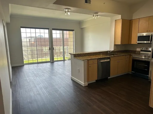 a view of a kitchen with a sink and a window