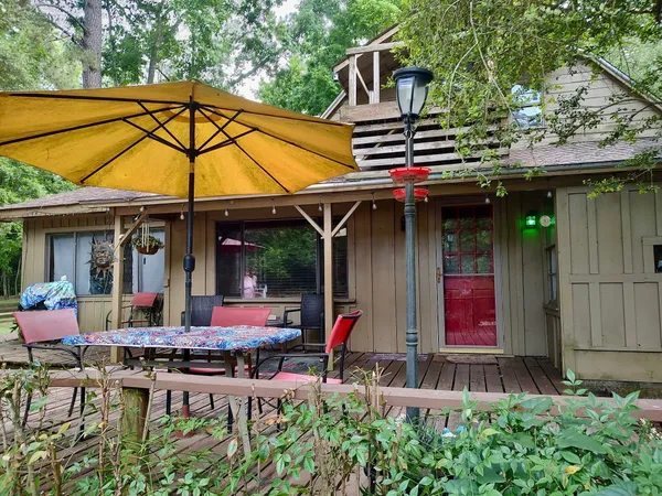 a patio with a table and chairs under an umbrella