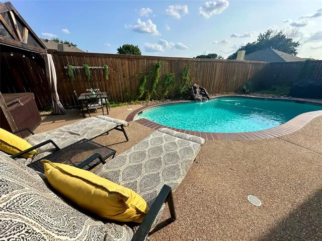 a view of a backyard with furniture
