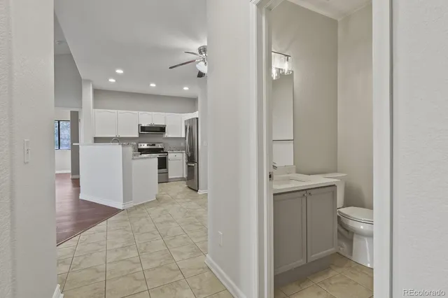 a view of a kitchen with wooden floor and electronic appliances