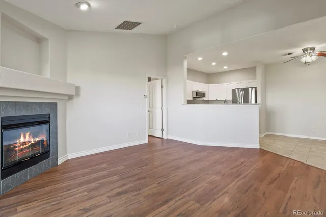 a view of a room wooden floor fire place and fire place