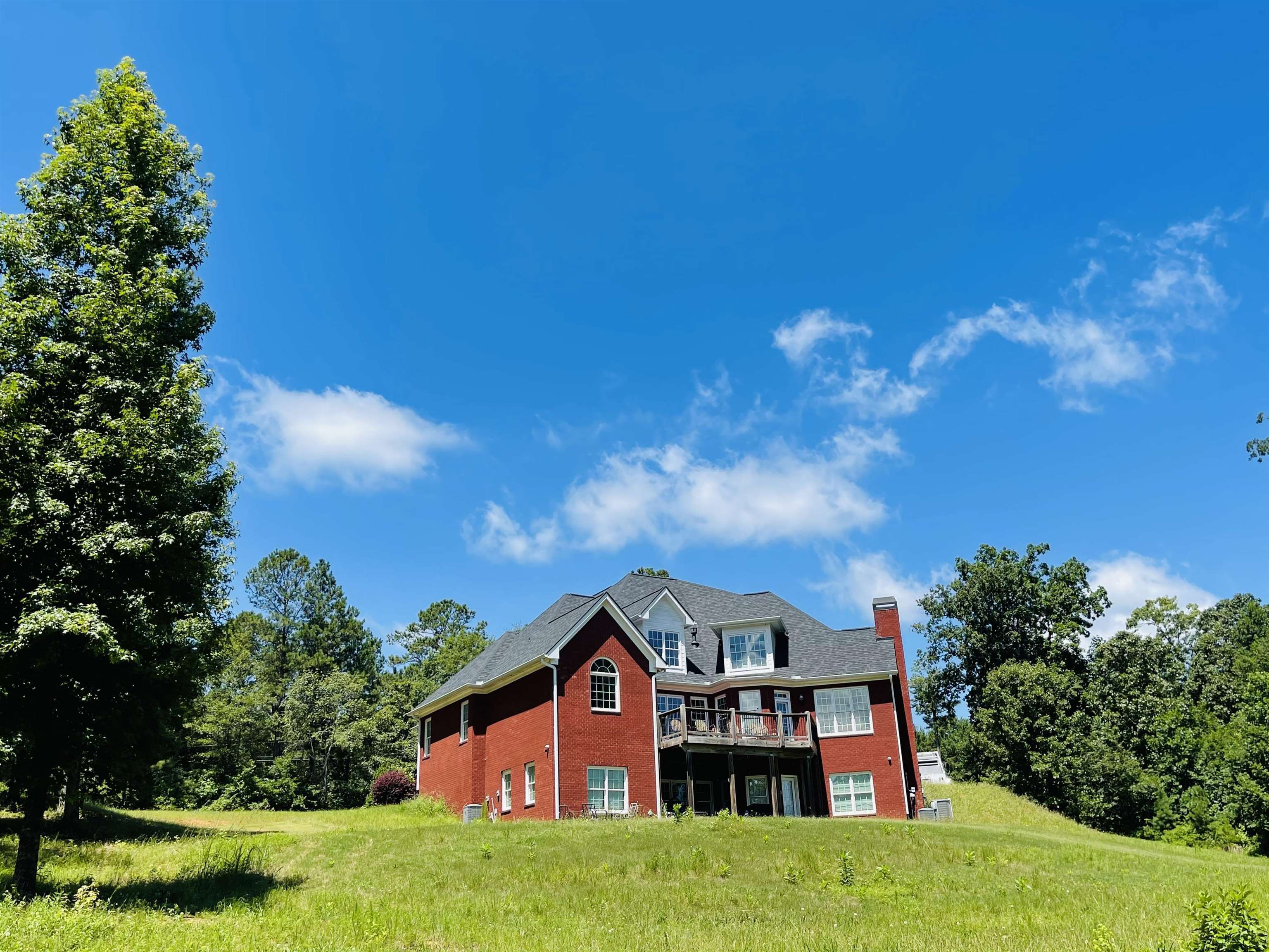 110 Kent Rock Road Loganville, GA 30052 - Photo 10 of 13 a view of a house with a big yard plants and large trees