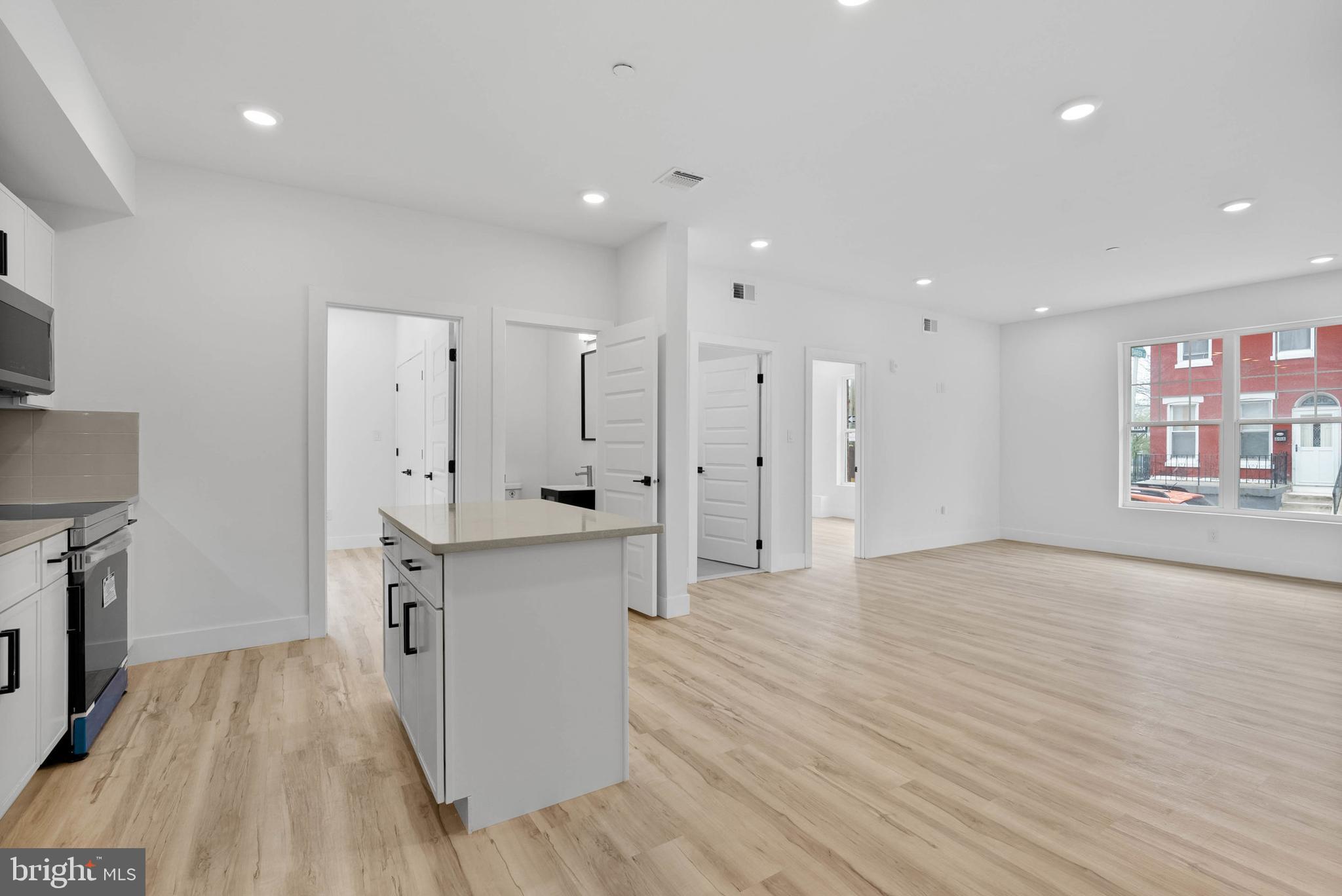 809 Diamond Street, Unit A101 Philadelphia, PA 19122 - Photo 3 of 17 a kitchen with stainless steel appliances a refrigerator sink and cabinets