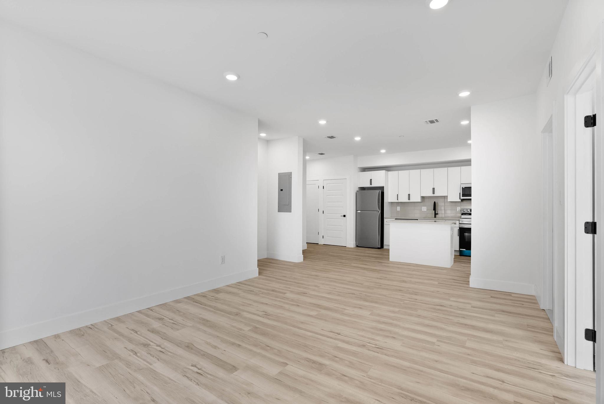 809 Diamond Street, Unit A101 Philadelphia, PA 19122 - Photo 5 of 17 a view of a kitchen with a sink and a refrigerator