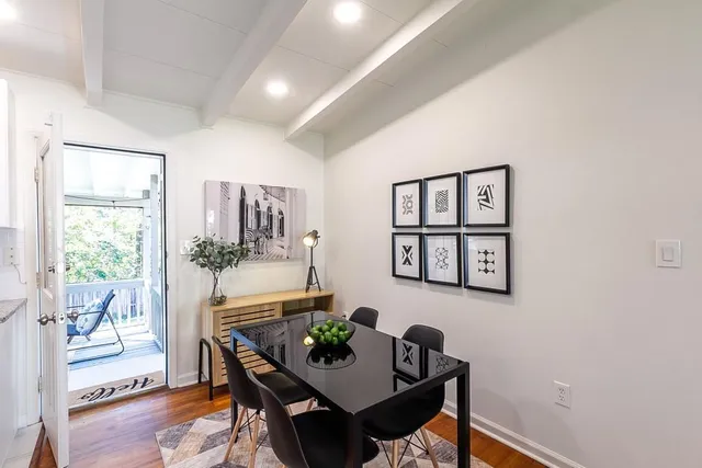 a view of a dining room with furniture and wooden floor