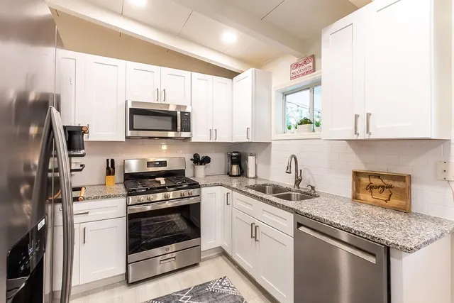 a stove top oven sitting inside of a kitchen