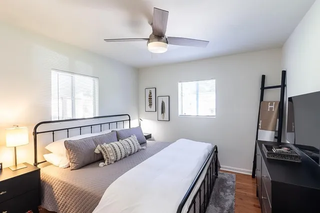 a bedroom with a bed and a chandelier