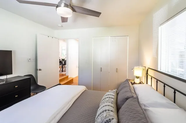 a bedroom with a bed and window