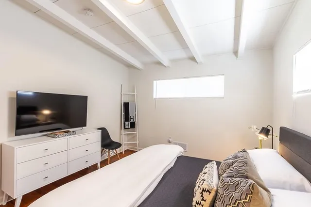 a view of a workspace with furniture and wooden floor
