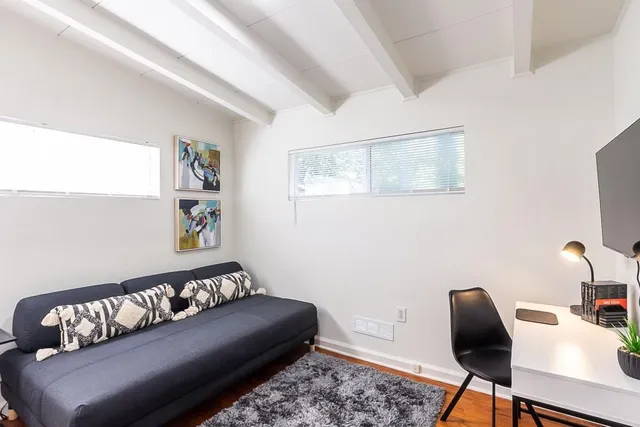 a bathroom with a granite countertop toilet sink and mirror